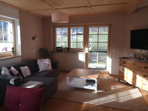 a living room with a couch and a coffee table at Apartment Stoderzinken, gemütlich und ruhig in Gröbming
