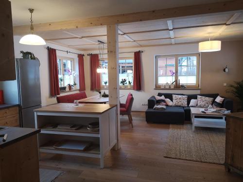 a living room with a couch and a table at Apartment Stoderzinken, gemütlich und ruhig in Gröbming