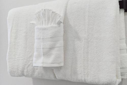 a stack of white towels hanging on a wall at Peaceful 1-BR Stay w/ Putting Green near Downtown in Oak Cliff