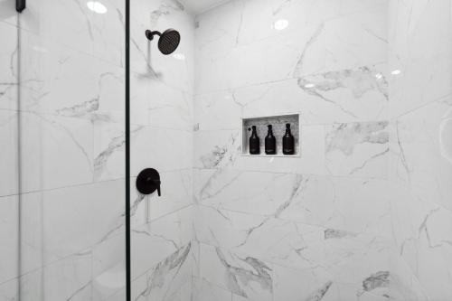 a bathroom with a shower with two bottles of wine at Peaceful 1-BR Stay w/ Putting Green near Downtown in Oak Cliff