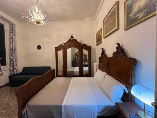 a bedroom with a bed and a chair and a mirror at Genova Antica in Genova