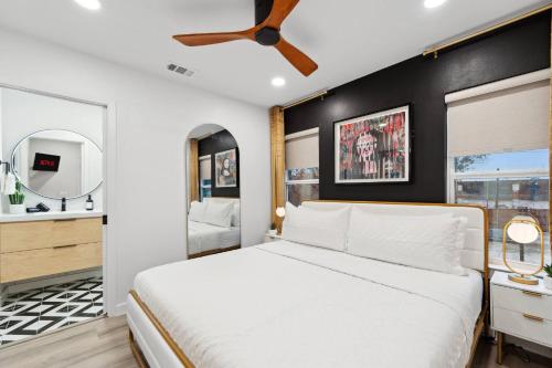 a bedroom with a white bed and a black wall at Peaceful 1-BR Stay w/ Putting Green near Downtown in Oak Cliff