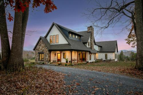a white house with a black roof at The Indigo House, an adults only, modern bed and breakfast for outdoorsy humans and kind dogs in Afton