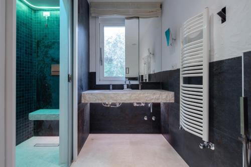a bathroom with a large sink and a shower at Villa Smeralda Punta Lada Porto Rotondo in Porto Rotondo