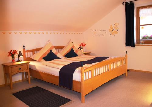 a bedroom with a large wooden bed in a room at Ferienwohnung Erhard in Schönberg