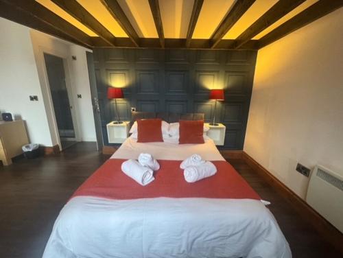 a bedroom with a large bed with towels on it at Ivy By The Sea in Scarborough