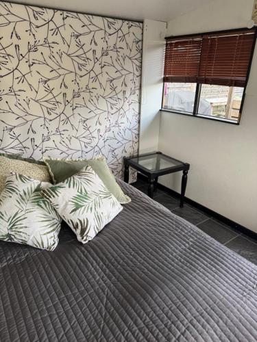 a bedroom with a bed with a wall at The Pigeon Hole in Ribe