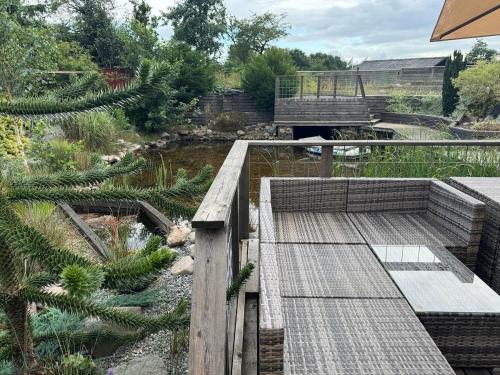 a garden with a wooden deck and a bridge at The Pigeon Hole in Ribe