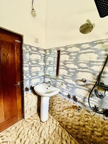a bathroom with a sink and a shower at Dinsara Villa Mirissa,Kamburugamuwa in Kamburugamuwa