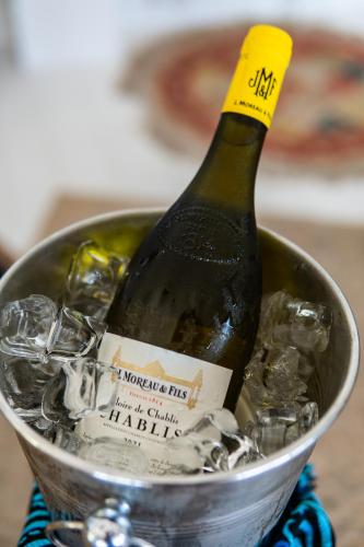 a bottle of wine in a bucket of ice at Villa Paradis by Casa Paradis in Jambiani