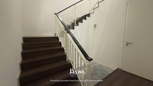 a staircase in a house with wooden floors at Onsen Premium Suites @ Tambun Ipoh in Ipoh