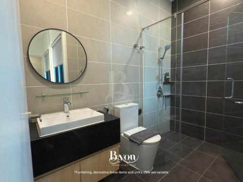 a bathroom with a sink and a toilet and a mirror at Onsen Premium Suites @ Tambun Ipoh in Ipoh