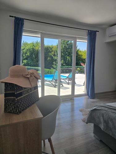 a bedroom with a view of a swimming pool and a room with a bed at Villa Heaven Green in Pazin