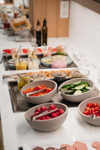 a buffet with bowls of vegetables on a table at Ringhotel Niedersachsen in Höxter