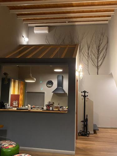 a kitchen with a counter in the middle of a room at Studio O F 2 in Leonforte