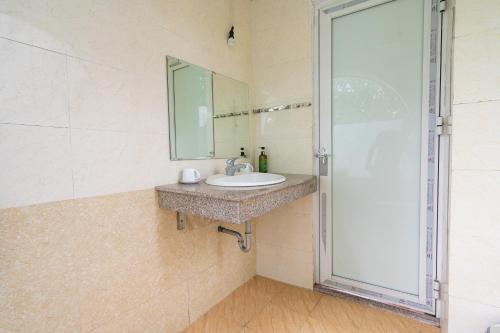a bathroom with a sink and a mirror at Lumiere Family Village Ba Vì in Ba Vì