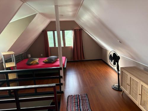 a bedroom with a bunk bed in a attic at Faatiarau Lodge in Fare