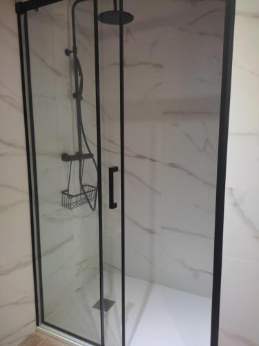 a glass display cabinet with a black frame at LolaPlayadeCarnota in Pedrafigueira