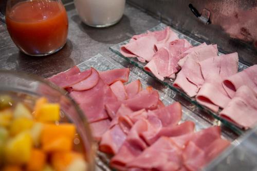 a bunch of ham and fruit on a table at Hostellerie Du Mont Aimé in Bergères-lès-Vertus
