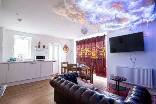 a living room with a couch and a ceiling with clouds at Magical Harry Potter Retreat 9 Mins to Studio Tour in Leavesden Green