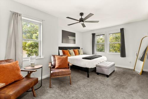 a bedroom with a bed and two windows at Spacious Retreat with Pool & Hot Tub - 10 Minutes to Downtown in San Antonio