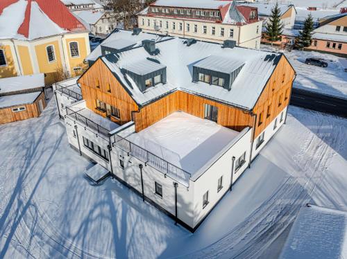 an aerial view of a house in the snow at Apartmán Rozárka in Deštné v Orlických horách
