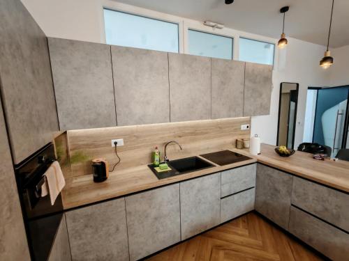 a kitchen with a sink and a counter at The White House Split in Split