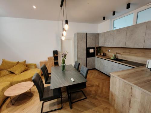 a kitchen and living room with a table and a couch at The White House Split in Split