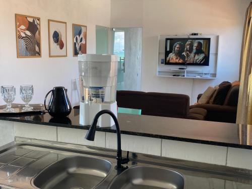 a kitchen with a counter top with a mixer on a sink at Apto em Itaparica condomínio in Itaparica Town