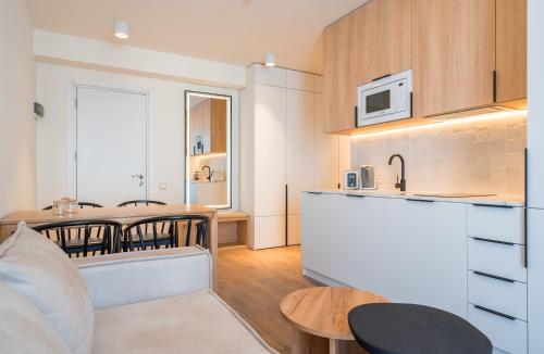 a kitchen and living room with a table and chairs at Evdo Apartments F1 Modern house in Kʼumlistsʼikhe