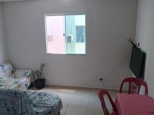 a room with a table and a chair and a window at Cozy apartment-COP 30 in Ananindeua