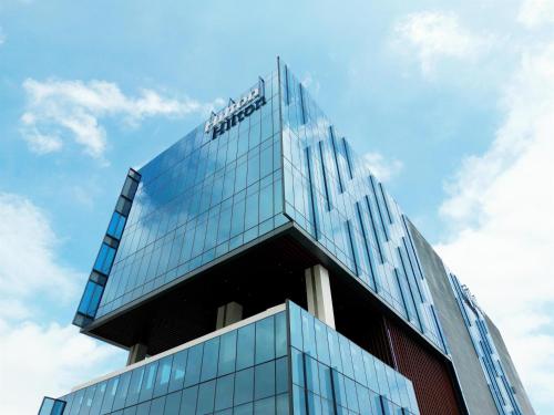 a building with a sign on top of it at Hilton Monterrey Valle in Monterrey