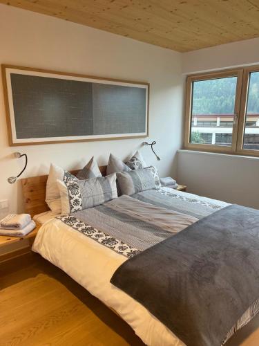 a bedroom with a large bed with a chalkboard on the wall at Chalet Tonin in Fulpmes
