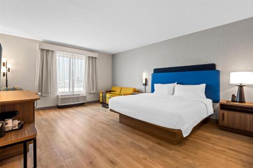 a bedroom with a large bed with a blue headboard at Hampton Inn & Suites Intercourse, Pa in Intercourse