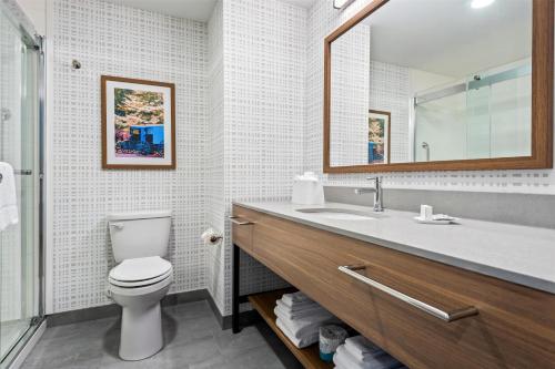 a bathroom with a toilet and a sink and a mirror at Hampton Inn & Suites Intercourse, Pa in Intercourse