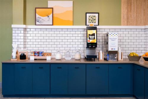 a counter in a kitchen with blue cabinets at Spark By Hilton Orangeburg in Orangeburg