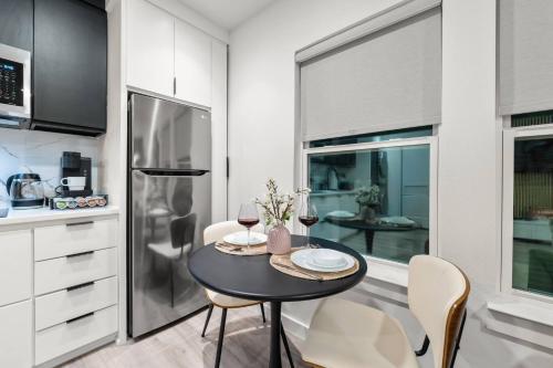 a kitchen with a table and two glasses of wine at Japandi Style 1BR Escape w EV Charger, Bishop Arts in Oak Cliff