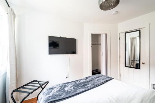 a bedroom with a bed and a tv on the wall at East Side Spa Retreat Near Lake in Milwaukee
