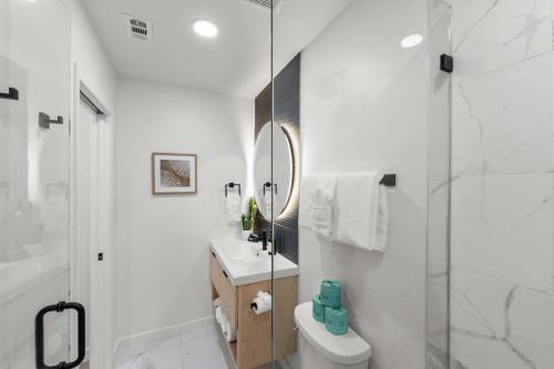 a bathroom with a shower and a toilet and a sink at Japandi Style 1BR Escape w EV Charger, Bishop Arts in Oak Cliff
