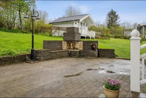 a backyard with a fireplace and a house at KB - Villa sentrum Leknes in Vestvågøya