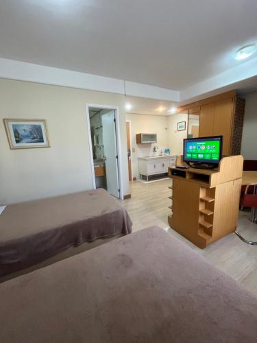 a bedroom with a bed and a flat screen tv at Hotel Biena Sena Madureira PqIbirapuera Com Garagem 907 in Sao Paulo