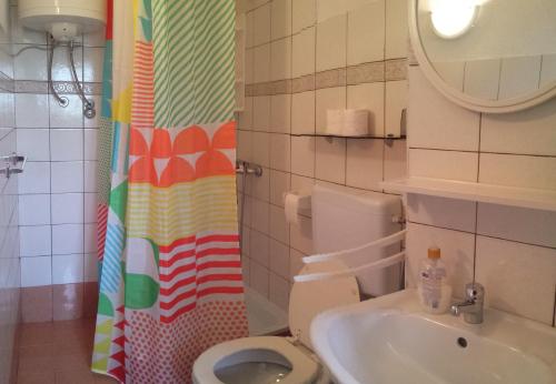 a bathroom with a toilet and a sink at Apartments Antica in Šimuni