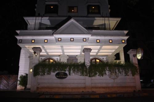 a white building with a sign on it at night at Hotel Karl Residency in Mumbai