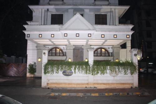 a large white building with ivy on it at Hotel Karl Residency in Mumbai