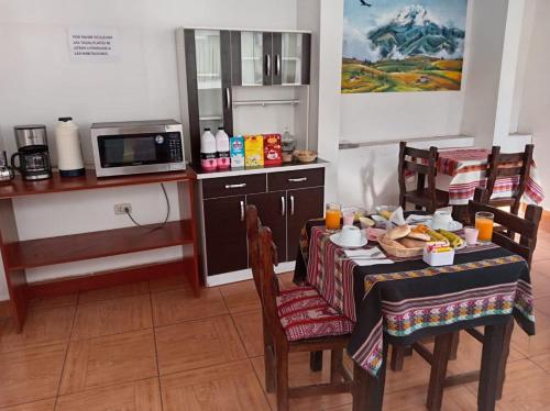 a kitchen with a table with food on it at Hosp Sophie in Cusco