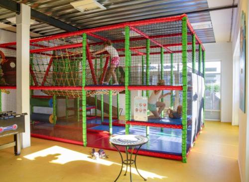 a room with a play structure with people in it at Recreatie Chalet in Dordrecht