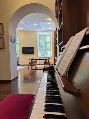 a piano in the middle of a living room at Colosseum's Custodian - Apartment 115 m2 in Rome