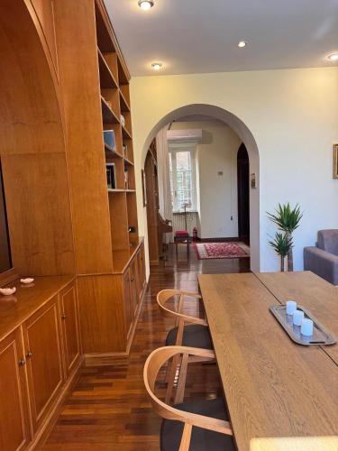 a living room with a wooden table and chairs at Colosseum's Custodian - Apartment 115 m2 in Rome