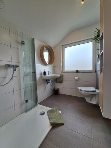 a bathroom with a shower and a toilet and a sink at Emstaler Auszeit in Bad Emstal