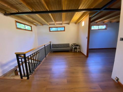 an empty room with a staircase and a couch at Comfortable modular home in San Esteban